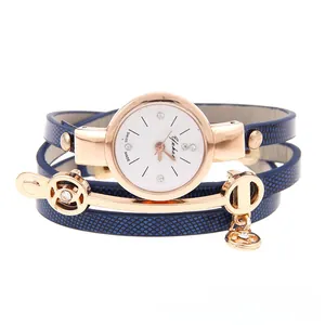 Detail of navy leather triple wrap watch strap with rose gold dial and crystal markers