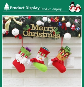 Close-up of Santa, Snowman and Reindeer Christmas stockings hanging with festive ornaments