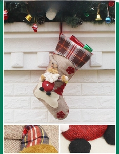 Detail of Christmas stocking featuring 3D Santa Claus figure and red snowflake embroidery