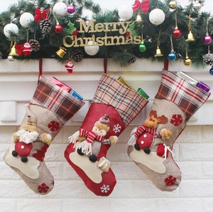 Detailed view of 3D Santa, Snowman and Reindeer Christmas stockings on festive wall
