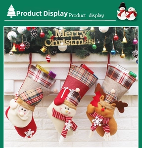 Detailed view of three 3D Christmas stockings with Santa, Snowman and Reindeer hanging