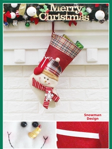 Detail of a Christmas snowman stocking decoration with plaid hat and striped scarf