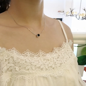Detail of 925 sterling silver necklace with black onyx bead on model neck