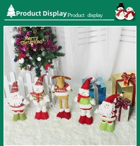 Close-up of plush Christmas dolls including Santa and Snowman in knitted sweaters