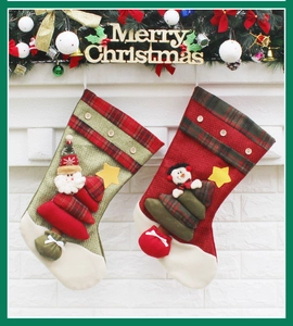 Detail of red and green Christmas stockings with 3D Santa and snowman on a festive mantel