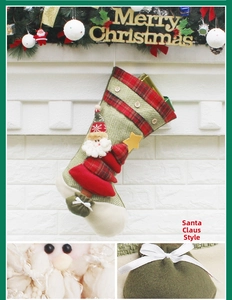 Detail view of Santa Claus Christmas stocking with 3D doll and plaid cuff ornament