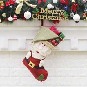 Classic red and green Santa Claus Christmas stocking hanging by a fireplace mantel