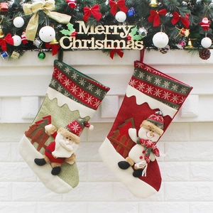 Christmas stockings with Santa and Snowman hanging on a festive decorated mantelpiece