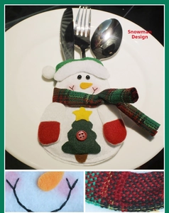 Detailed view of Snowman style Christmas cutlery holder with steel knife fork and spoon