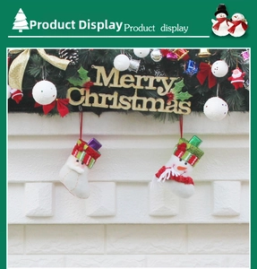 Detail of plush Christmas stocking ornaments with Santa and Snowman hung on a fireplace