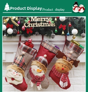 Detail of Christmas stockings set with Santa Snowman and Reindeer on brick wall