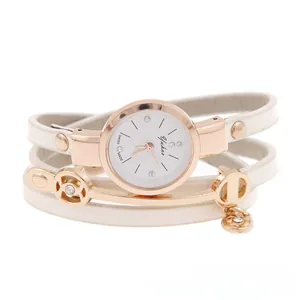 Detail of white wrap-around leather strap watch with rose gold case and floral charm