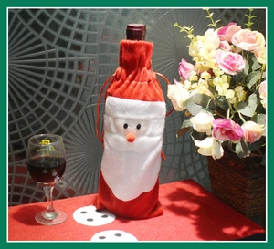Detail of red plush Santa Claus wine bottle cover with 3D nose and drawstring closure