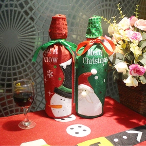 Detail of embroidered Christmas wine bottle covers with sequins and Let it Snow text