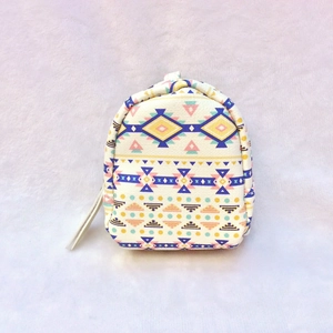 Close-up of a mini backpack coin purse with colorful ethnic geometric canvas patterns