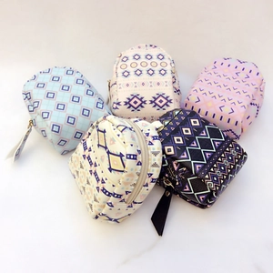 Top view of compact ethnic coin purses with geometric patterns and gold zippers