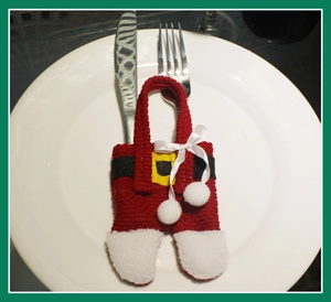 Christmas Santa pants cutlery holder placed on white plate as festive table decor