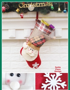 Close-up of Santa style Christmas stocking with felt fabric and plaid cuff details