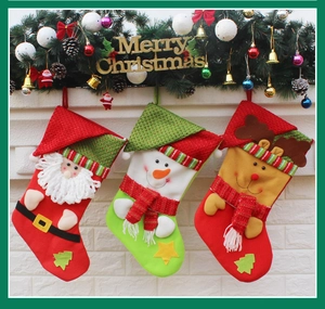 Three festive Christmas stockings featuring Santa, snowman and reindeer on a fireplace