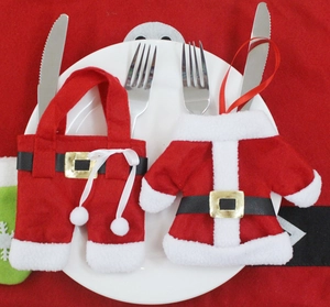 Detail of Christmas cutlery holder set with Santa suit design on a white ceramic plate