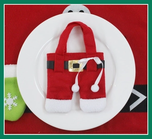 Close-up of Christmas tableware holder in Santa pants design on a white ceramic plate