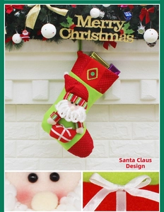 Detailed view of 3D Santa Claus applique and plaid fabric on green Christmas stocking