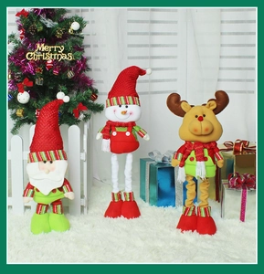Detail of Santa, Snowman and Reindeer plush dolls set on a festive white carpet
