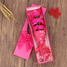 Detailed gift box with pink soap flower bouquet and matching shopping bag on wooden table