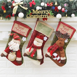 Three premium linen Christmas stockings with Santa, Snowman, and Reindeer 3D dolls