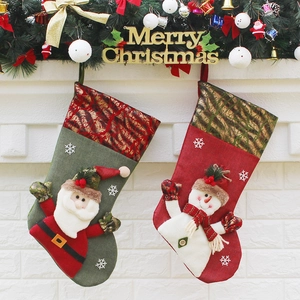 Festive Christmas stockings with Santa and Snowman hanging on fireplace mantel