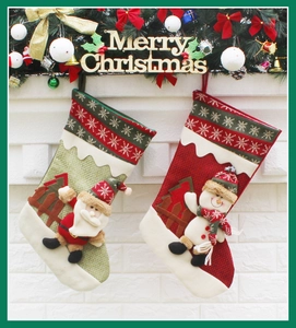 Close-up of knit Christmas stockings with 3D Santa and Snowman hanging on a white fireplace