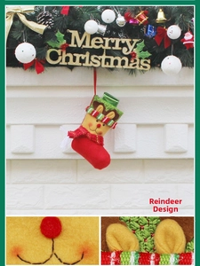 Detail of red plush Christmas stocking featuring a cartoon reindeer and knit trim