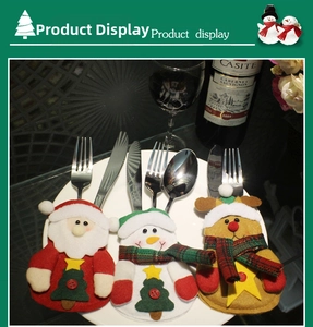 Detailed view of Santa, Snowman and Reindeer cutlery holders on white plate setting
