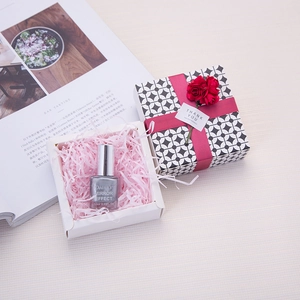 Lafite paper filler in geometric gift box with red ribbon and decorative roses