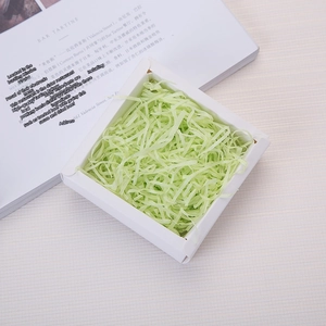 Light green shredded raffia paper filler in white gift box for packaging decoration