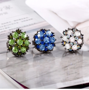 Detailed close-up of cluster rings with emerald and sapphire crystals in vintage finish