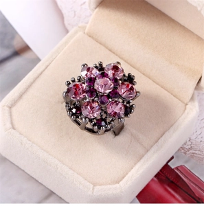 Detail of pink crystal flower ring with dark alloy base in velvet jewelry box