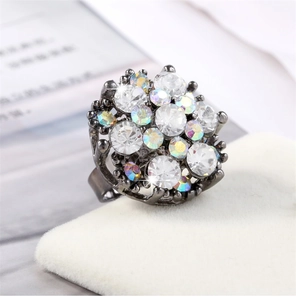 Macro detail of gunmetal cocktail ring with sparkling iridescent and clear crystals