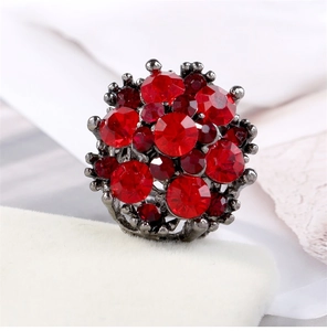 Macro detail of vintage alloy ring featuring a cluster of brilliant red zircon crystals