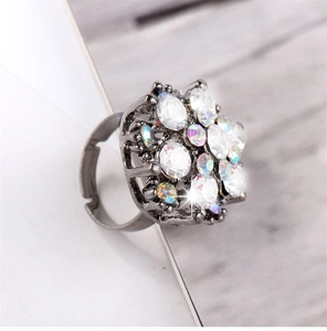 Detailed view of flower-shaped rhinestone ring with gun black finish and adjustable band
