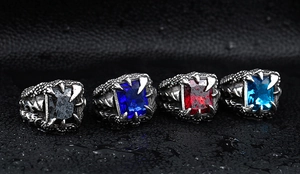 Detail of vintage dragon claw rings with multi-color cubic zirconia stones for men