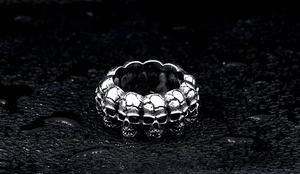 Macro detail of men's punk skull ring in antique silver finish with gothic engraving