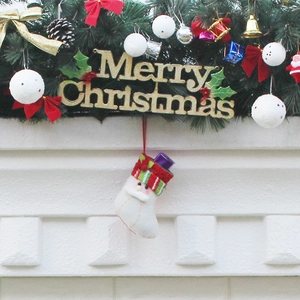Christmas pine wreath with Merry Christmas sign and Santa Claus felt stocking decoration