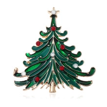 Detailed view of green enamel Christmas tree brooch with sparkling red and white crystals