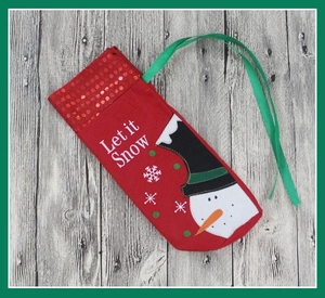 Detail of red Christmas wine gift bag with snowman embroidery and sequins