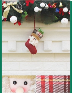 Detail of Santa Claus Christmas stocking featuring red fabric and plaid cuff decoration