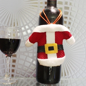 Festive red and white knitted wine bottle cover with a black belt for Christmas decor