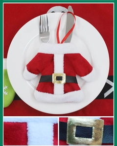 Detailed view of Santa clothes style cutlery holder on a plate for Christmas table setting