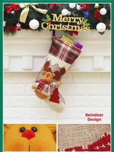 Close-up of rustic Christmas stocking with 3D plush reindeer and plaid fabric texture