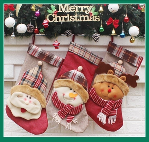 Hanging Christmas stockings with Santa, snowman and reindeer designs on a white mantel